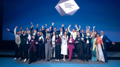 A group photo on stage showing all the winners of the Digital Economy Awards 2025.