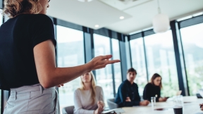 Businesswoman giving instructions to her colleagues in office